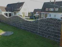 imagen de muro de piedra con ondulaciones en su parte superior